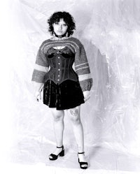 a woman in a corset posing for a photo