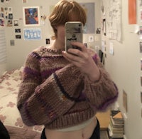 a woman taking a selfie in her bedroom